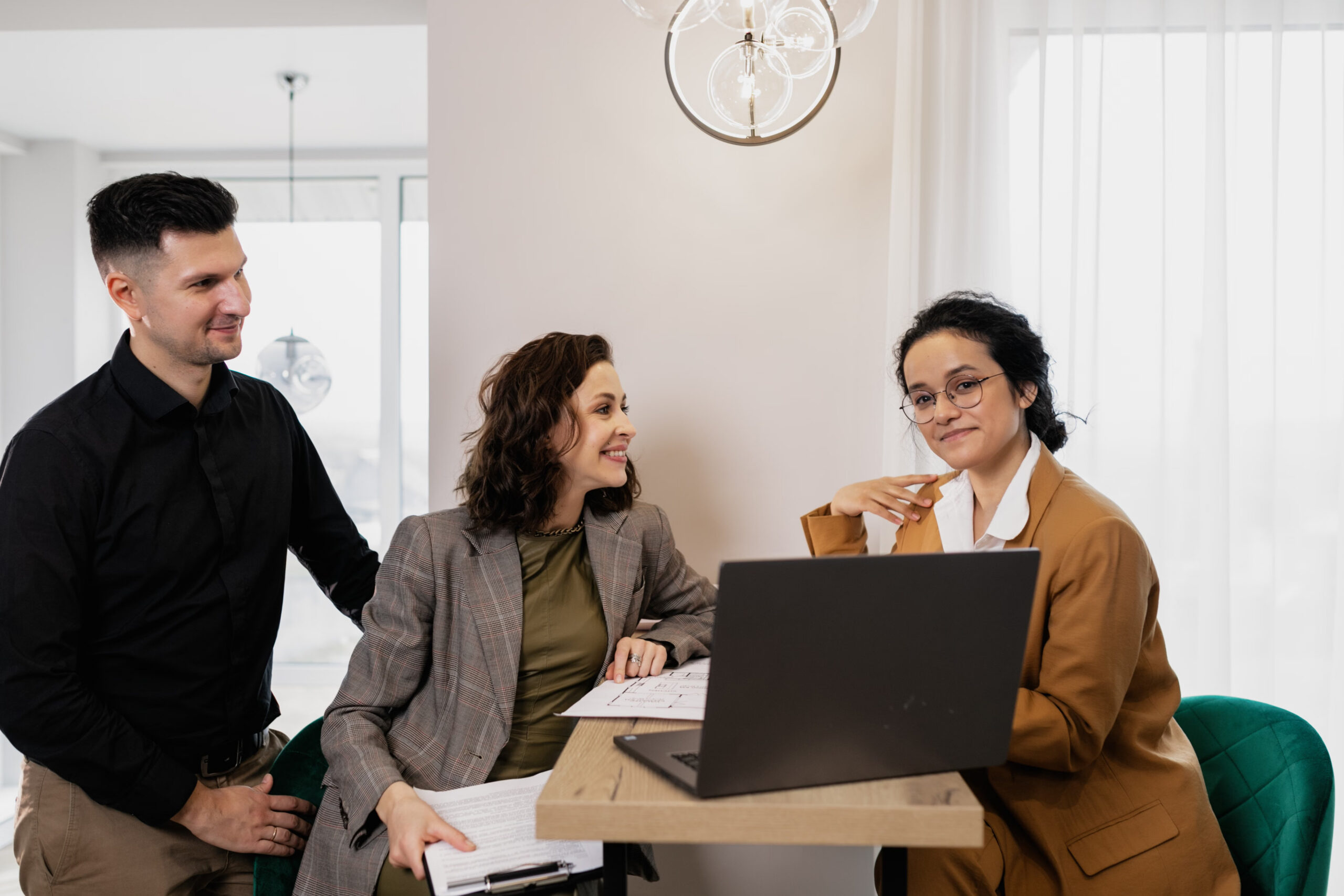Young direct marketing professionals collaborating during a client strategy meeting.